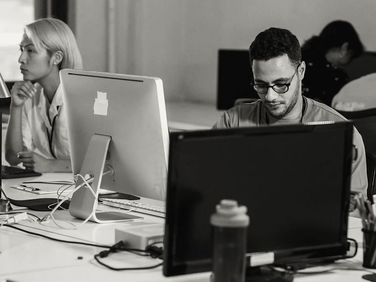 Office staff working at their desks and computers.
